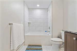 Full bath with shower / washtub combination, light marble finish floors, and vanity