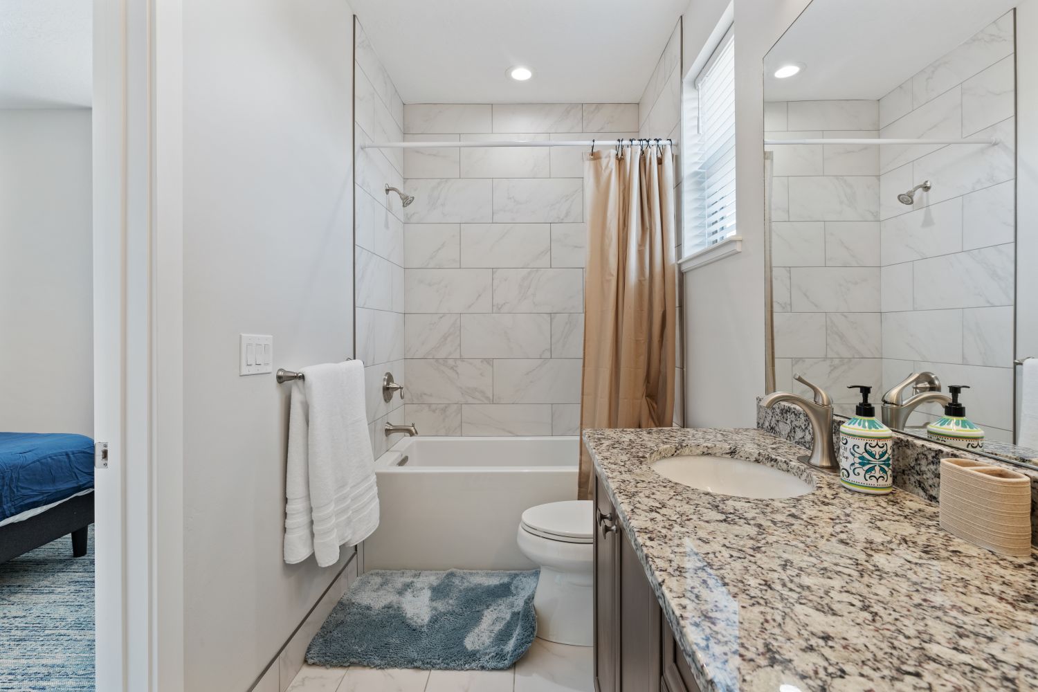 Bathroom featuring shower / bathtub combination with curtain and vanity