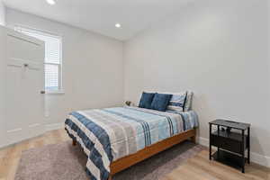 Bedroom featuring light wood finished floors and recessed lighting