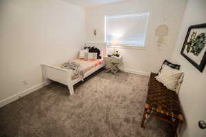 Bedroom featuring carpet flooring and baseboards