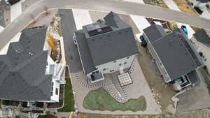 Aerial view of property and surrounding area featuring nearby suburban area