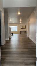 Hallway featuring wood finished floors and stairway