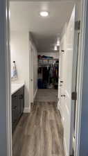 Corridor with dark wood-style floors and baseboards