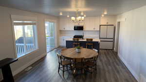 Dining space featuring a chandelier and dark wood finished floors