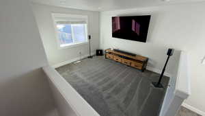 Living room featuring baseboards and carpet