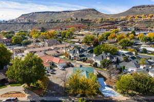 Aerial overview of property's location featuring a mountainous background and nearby suburban area