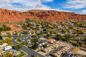 Aerial overview of property's location with nearby suburban area and a mountain backdrop