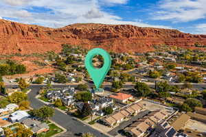 Aerial overview of property's location with nearby suburban area and a mountain backdrop