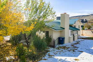 Snow covered property featuring a metal roof