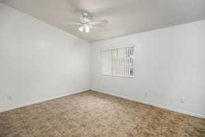 Empty room featuring baseboards and ceiling fan