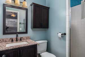 Bathroom featuring vanity and tiled shower