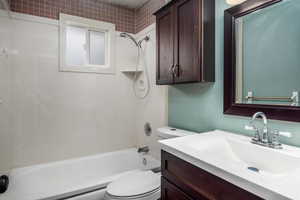 Full bath featuring vanity and shower / bath combination