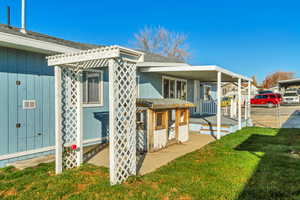 View of side of property with roof with shingles and a porch