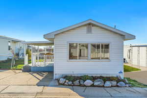 View of side of home with a gate
