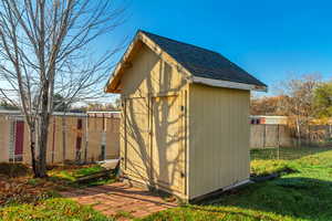 View of shed with a fenced backyard