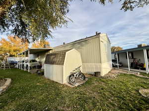 View of shed with an attached carport