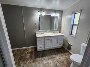 Full bath with double vanity and ornamental molding
