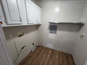Washroom featuring dark wood-style flooring, electric panel, cabinet space, and hookup for a washing machine