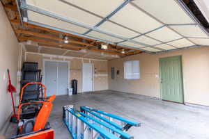 Garage with electric panel and a garage door opener  Side door.