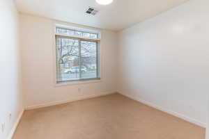 Bedroom with carpet floors and baseboards, and closet.