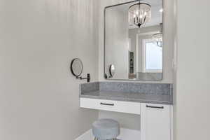 Bathroom featuring vanity and a chandelier