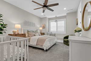 Bedroom with light colored carpet, a ceiling fan, and recessed lighting