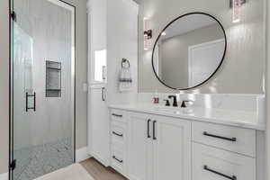 Full bath featuring vanity and a shower stall