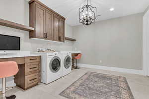 Washroom with independent washer and dryer, a chandelier, an office area, recessed lighting, and cabinet space
