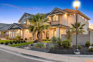 View of front of house with stone siding and stucco siding