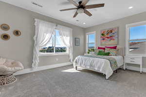 Carpeted bedroom with baseboards and ceiling fan