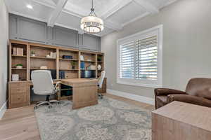 Office area with coffered ceiling, beamed ceiling, and light wood-type flooring