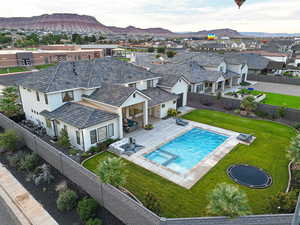 Aerial perspective of suburban area with a mountainous background and a pool area