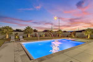 View of pool with a fenced backyard and a patio area