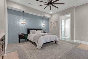 Bedroom with an accent wall, light carpet, ceiling fan, ensuite bath, and recessed lighting