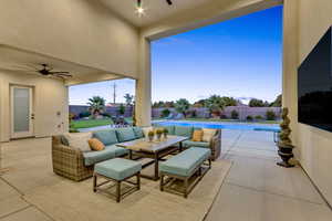 Fenced backyard with ceiling fan, a patio, and an outdoor living space