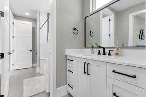 Bathroom with vanity, curtained shower, and light tile patterned floors