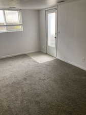 Unfurnished room featuring light carpet and baseboards