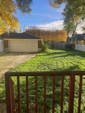 View of yard featuring a detached garage and an outdoor structure
