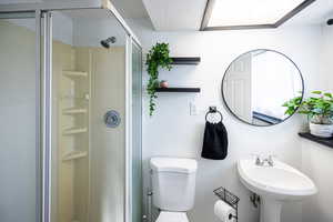 Full bath with a stall shower and a textured ceiling