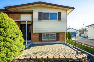 View of front of house with brick siding and a patio