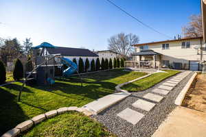 Fenced backyard with a gazebo and a playground