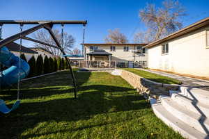 Back of house with a gazebo, a lawn, and a patio