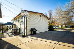 View of property exterior with a patio and a gazebo