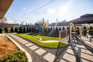 Fenced backyard featuring a gazebo and outdoor dining space