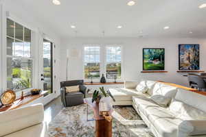 Bright and beautiful living room, with ample natural light, and space included with the entrance to the patio