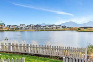 Lush lawn lined with a charming white fence perfect for pets and children to play
