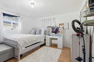 Bedroom featuring light wood-type flooring and baseboards