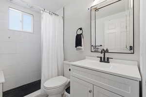 Bathroom with vanity and tiled shower