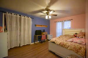 Bedroom with wood finished floors and ceiling fan