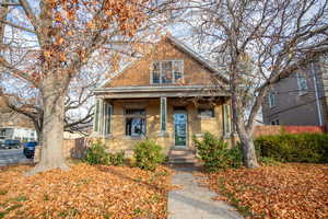 Bungalow with covered porch and brick siding